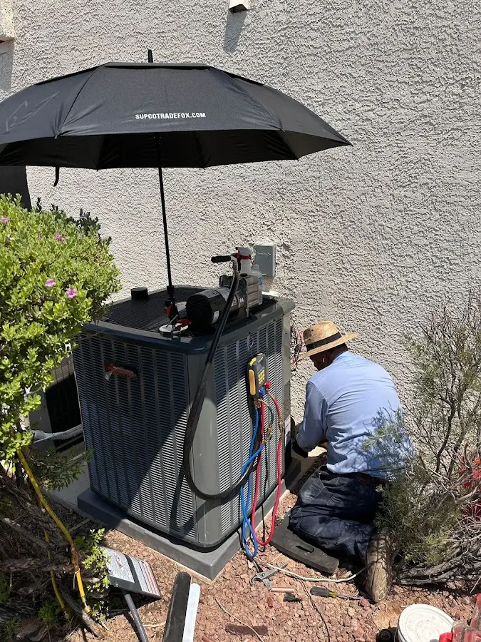 HVAC technician performing outdoor AC maintenance in Simi Valley