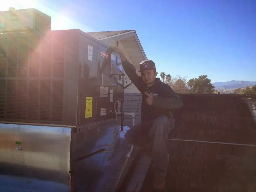 HVAC technician performing AC Tune-Up on a rooftop unit in Simi Valley